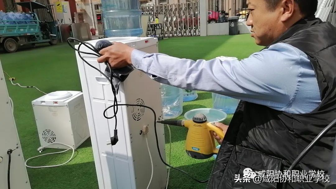 【校园安全】咸阳协和职业学校对全校的饮水机进行专业清洗